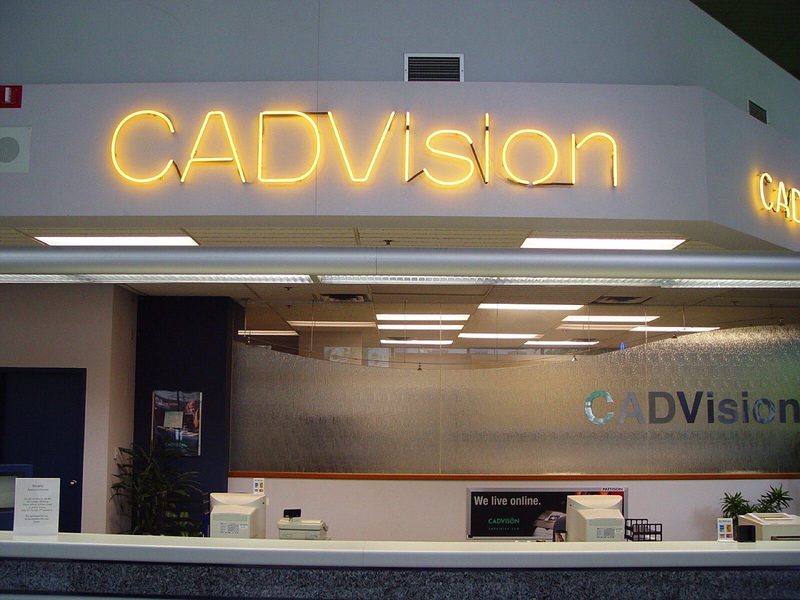 The reception wall — CADVision neon over frosted glass