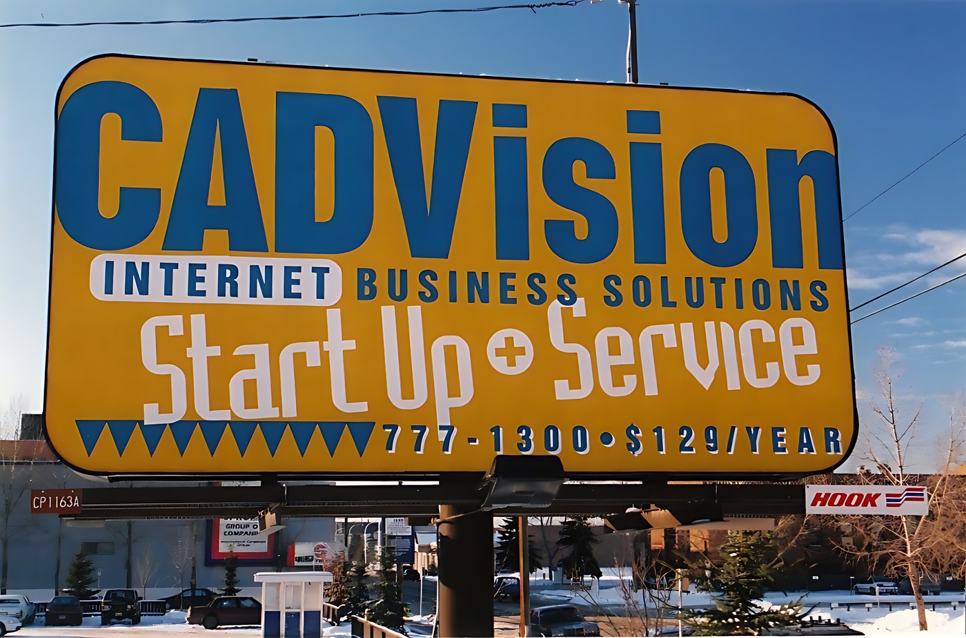 Photograph of a large yellow billboard with the words "CADVISION Interne